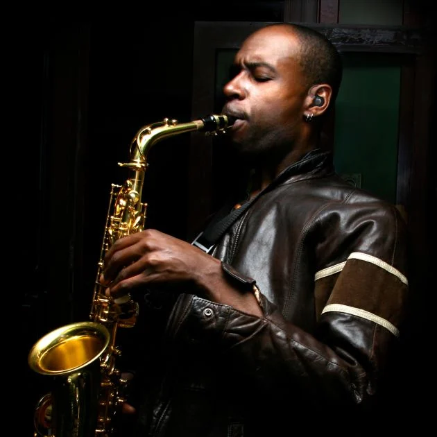 Musician using hearing protection while playing saxophone